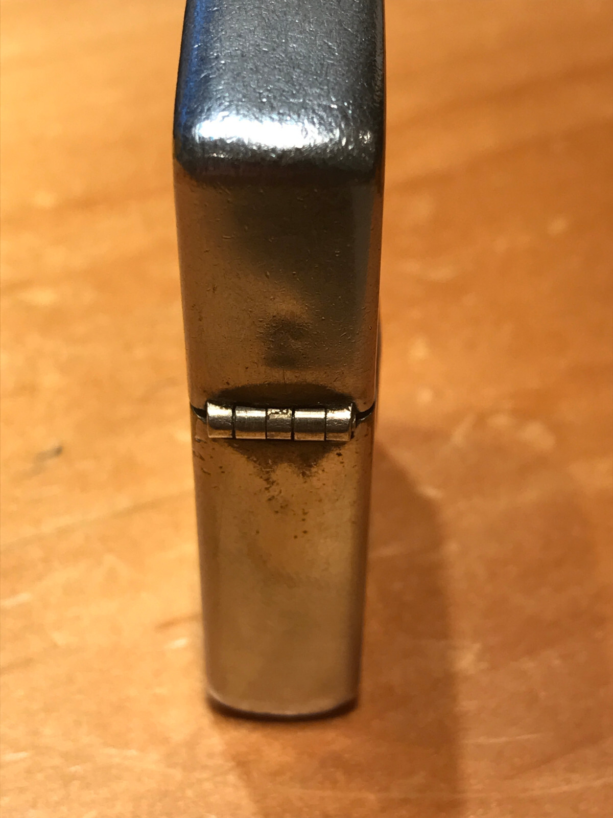 VINTAGE BRUSH CHROME ZIPPO LIGHTER WITH METAL EMBLEM ON THE FRONT PAT. 2517191