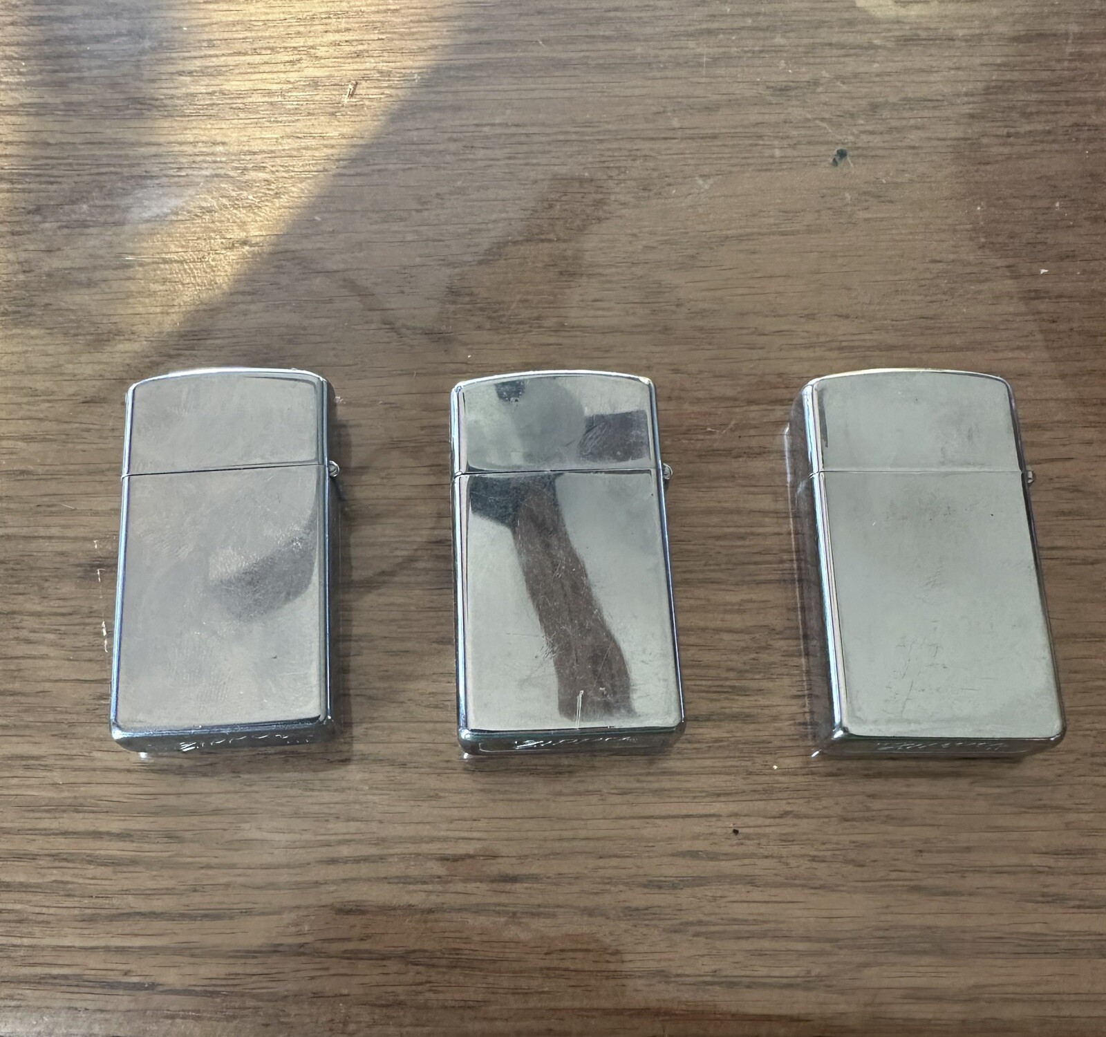 lot of 3 vintage Singer zippo lighters. Dwk160